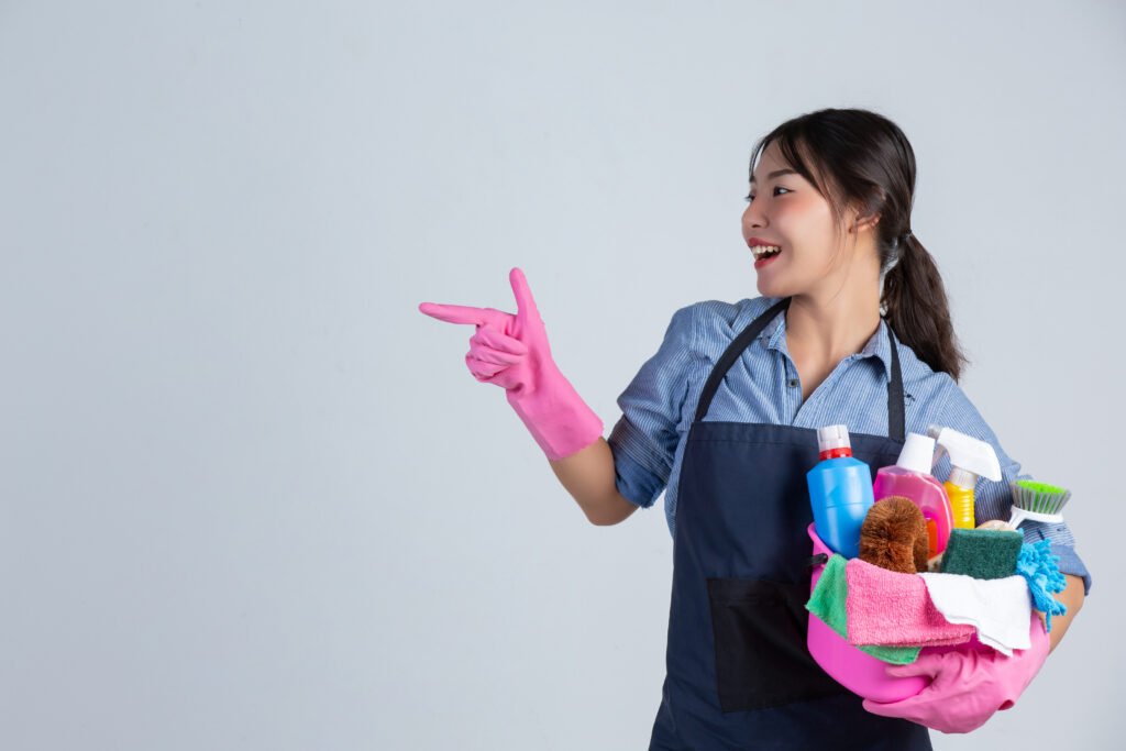housewife is wearing yellow gloves while cleaning