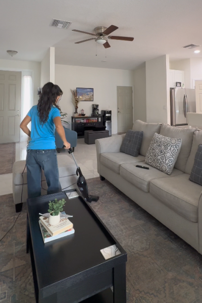cleaning team vacuuming modern home interior